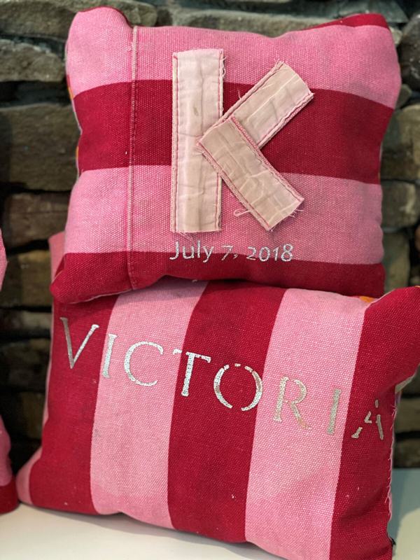 Pink pillows with monogram K and VICTORIA lettering