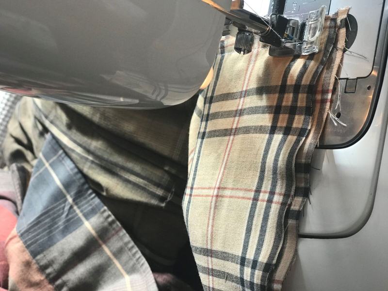 Lisa sewing a memory pillow from a plaid shirt